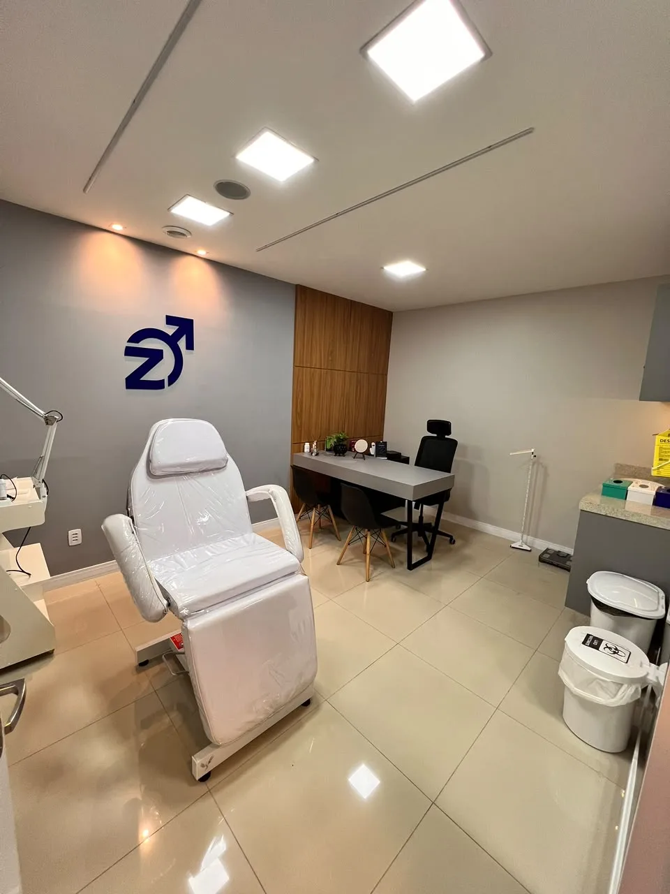 Sala privativa da Homenz São Carlos, com cadeira de procedimento e mesa de atendimento